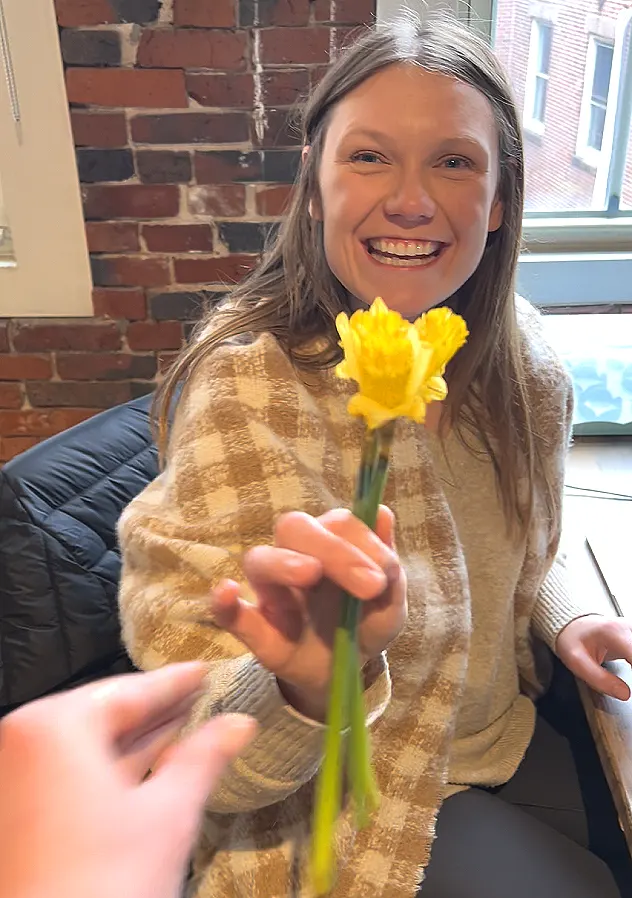 Surprised coworkers with yellow flowers